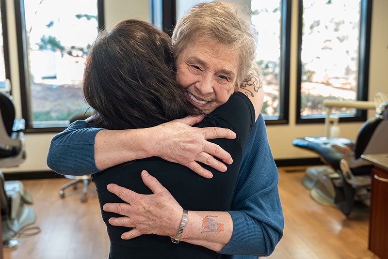 team member hugging Patient