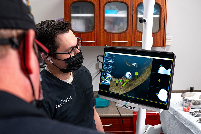 Doctors looking at 3d scans of patients teeth