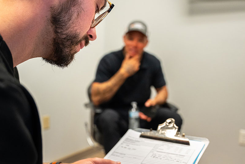 doctor writing down information for Patient