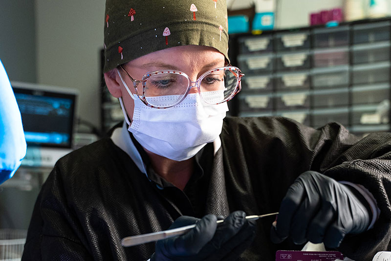 team member grabbing dental equipment